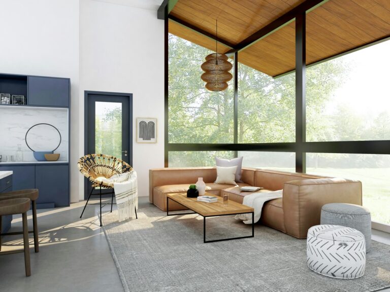 A sunlit living room with a leather sectional and floor-to-ceiling windows